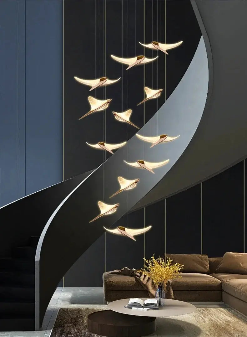 Seagull staircase pendant lamp by Simples Market; modern gold bird pendants along a curved black staircase.
