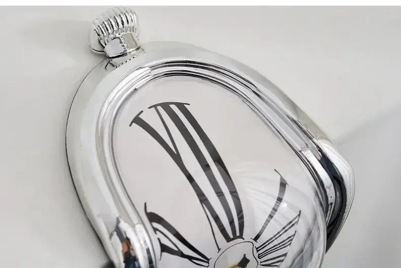 Surreal melting clock; silver-tone wall clock in Dali style with Roman numerals.