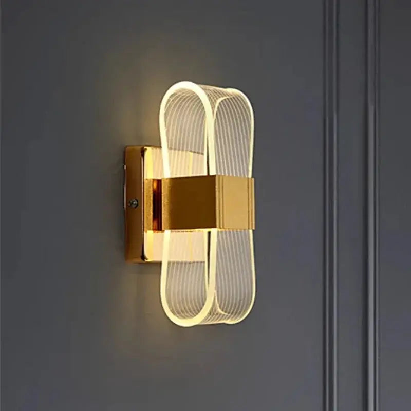 Nordic luxury LED wall lamp for bedside; gold aluminum body with ribbed loop design