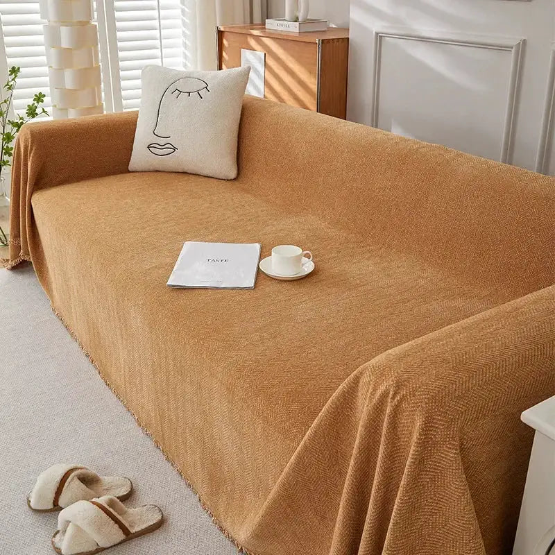 Couch cover in camel chenille with fringe by Simples Market on a sofa