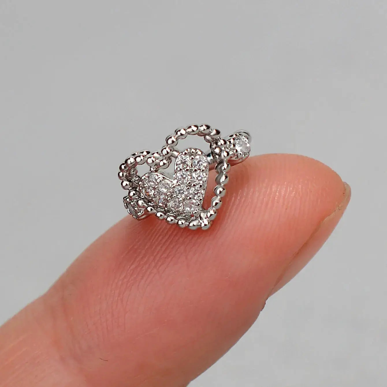 Simples Market clip-on heart earring with zircon pavé on a silver-tone beaded hoop ear cuff