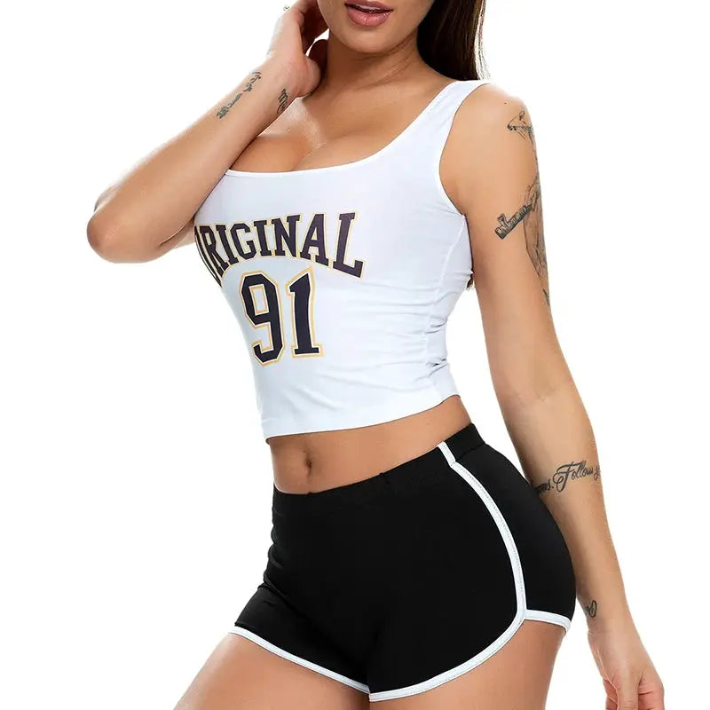 Women's black athletic shorts with white piping, paired with a white cropped top.