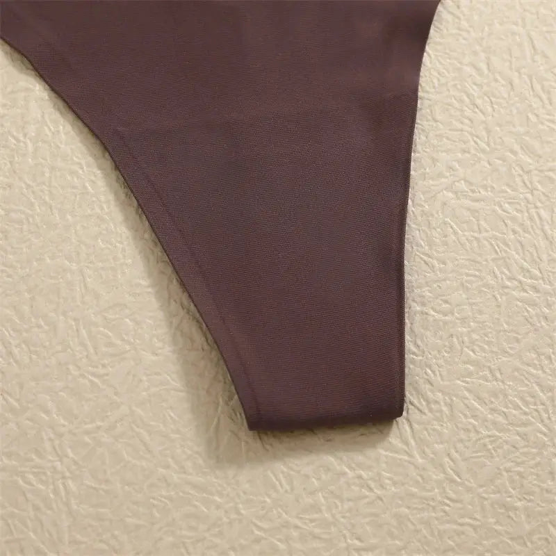 G-string thong panty in brown ice-silk fabric, seamless low-rise design.