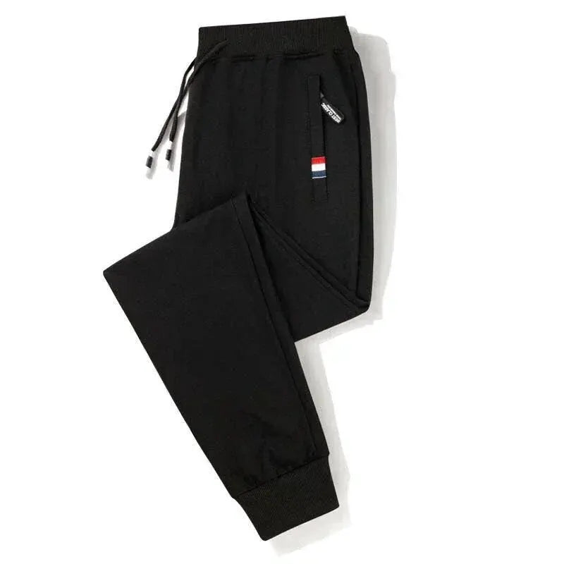 Black men's jogger track pants with elastic waistband and cuffed ankles in cotton fabric