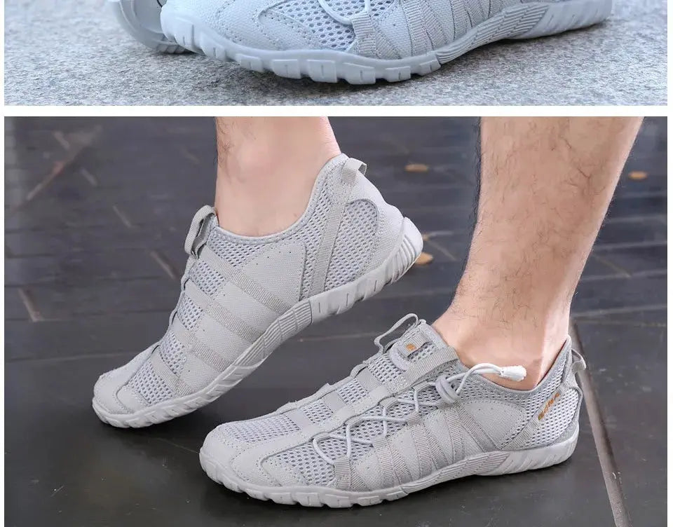 Pair of men's gray running shoes with mesh upper, breathable lace-up athletic sneakers