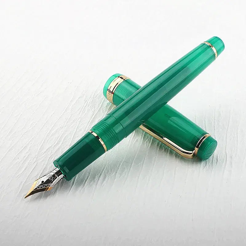 Two Jinhao 82 fountain pens in green acrylic with gold trim and converters