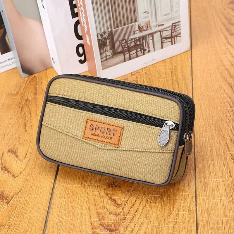 Men's tan canvas waist pack with front zip pocket and brown trim