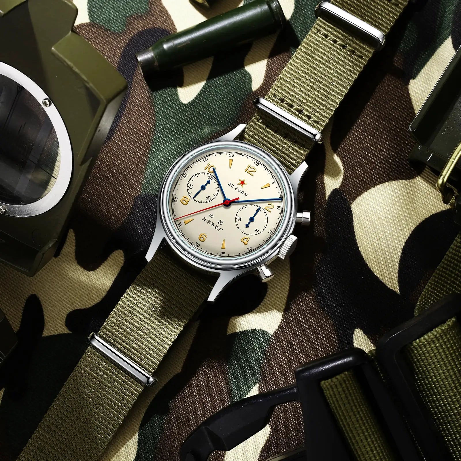 Seagull 1963 men's chronograph watch with cream dial, gold numerals, blue hands, red second hand, on olive NATO strap.