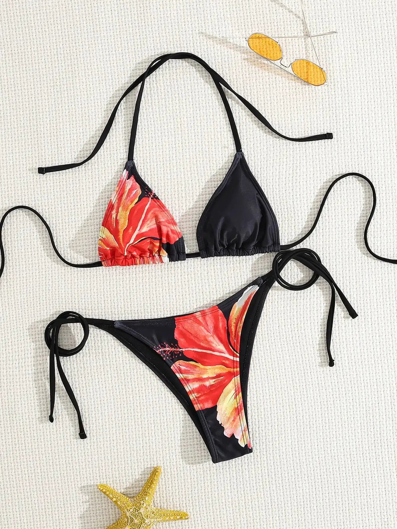 Women's two-piece bikini set with red floral-print triangle top and black adjustable ties; matching floral bottom
