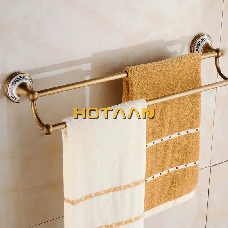 Antique brushed solid brass bathroom hardware set with porcelain wall mounts and two towel bars; white and tan towels.