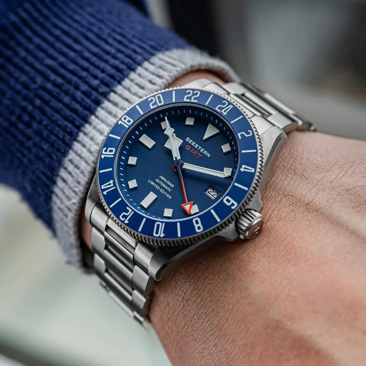 SEESTERN Diver watch on wrist with blue dial and blue bezel, stainless steel bracelet, GMT.