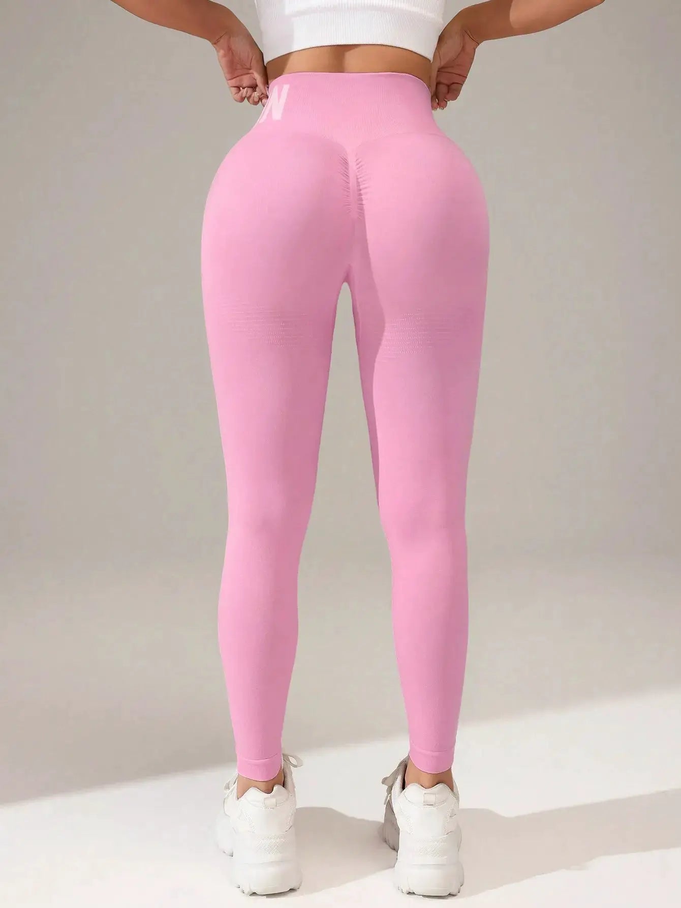 Yoga leggings, pink seamless high-waist with butt-lifting design and quick-dry breathable fabric.
