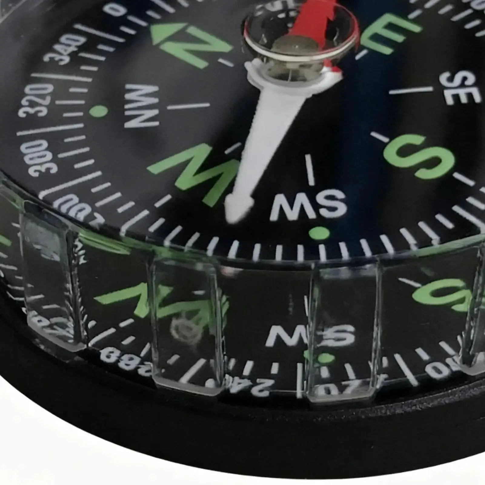 Simples Market waterproof hiking compass with white needle on a black dial and green N/S markings.
