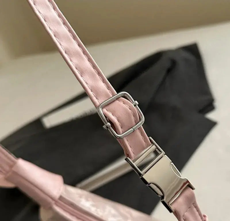 Pink handbag strap by Simples Market with metal buckle and swivel clasp.