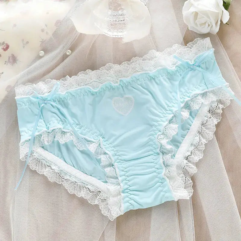 Panties in light blue ice-silk with white lace trim, heart motif on front and side bows.