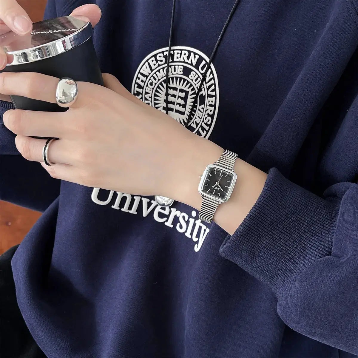 Women's quartz wristwatch with square black dial and adjustable stainless steel bracelet