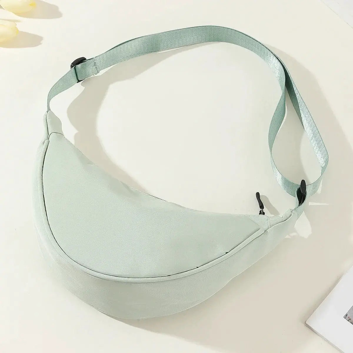 Simples Market nylon dumpling bag in mint green; lightweight, compact crossbody with adjustable strap.