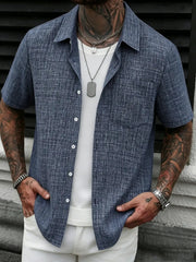Men's casual linen short-sleeve shirt in blue layered over a white tee.