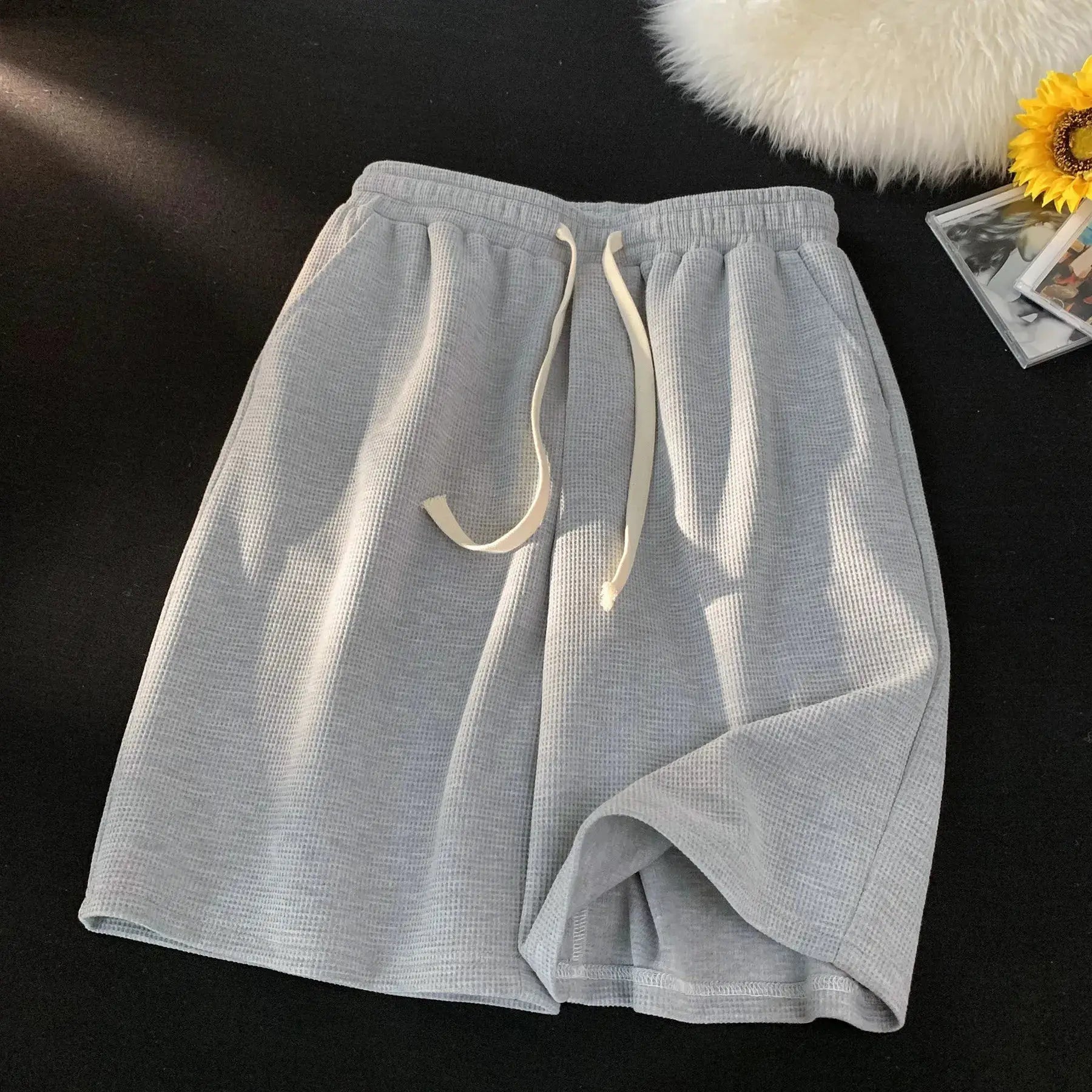 Waffle shorts, light gray fabric with drawstring waist, loose casual men's summer shorts.