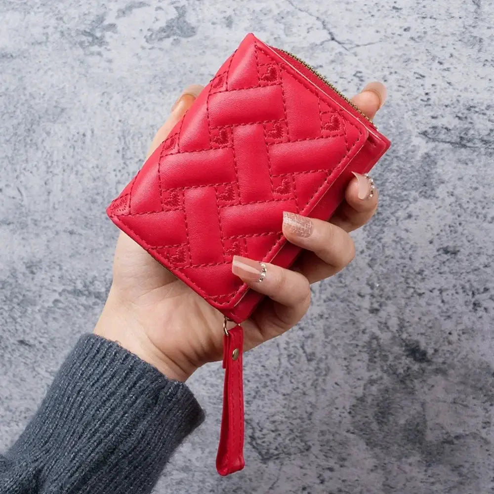 Red quilted Love Zero wallet by Simples Market with zipper and wrist strap