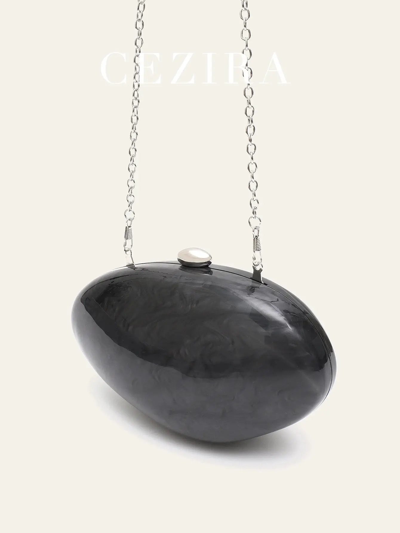 Shell-shaped acrylic clutch bag in black marbled finish with long silver chain