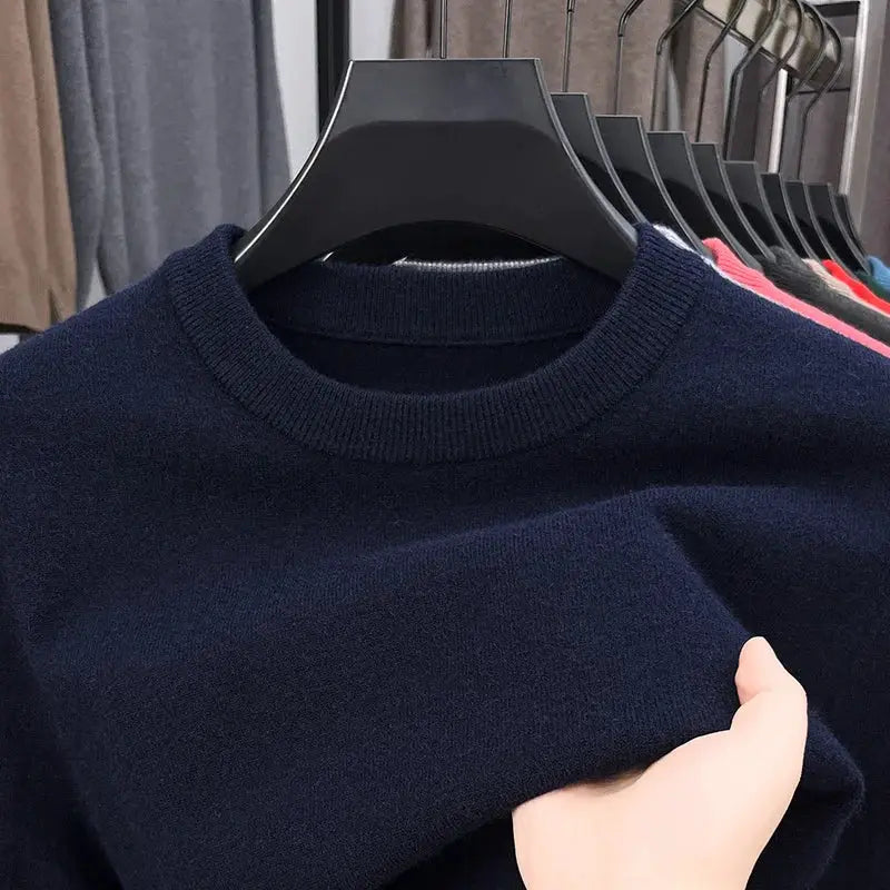 Men's navy round-neck knitted sweater on hanger; visible knit texture