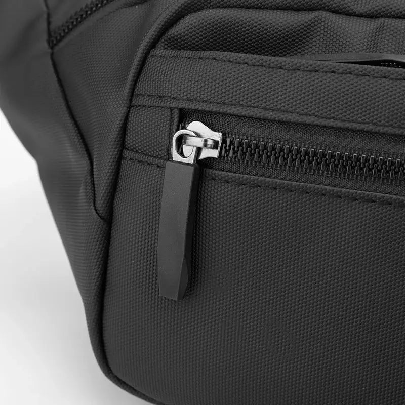 Unisex waterproof waist bag in black with a zippered pocket; compact travel belt pouch.