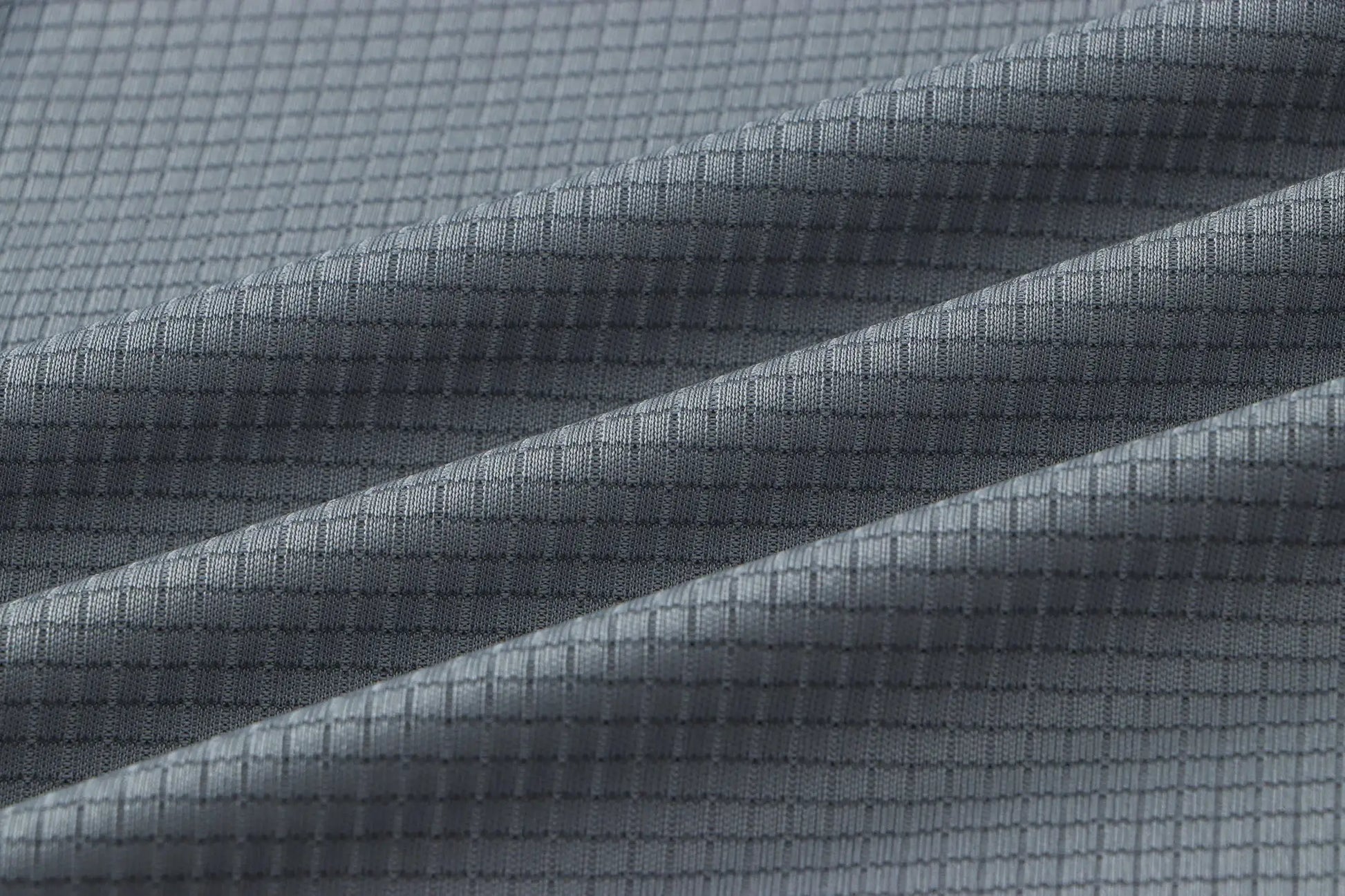 Men's quick-dry gym T-shirt fabric texture in gray with a grid-weave pattern.