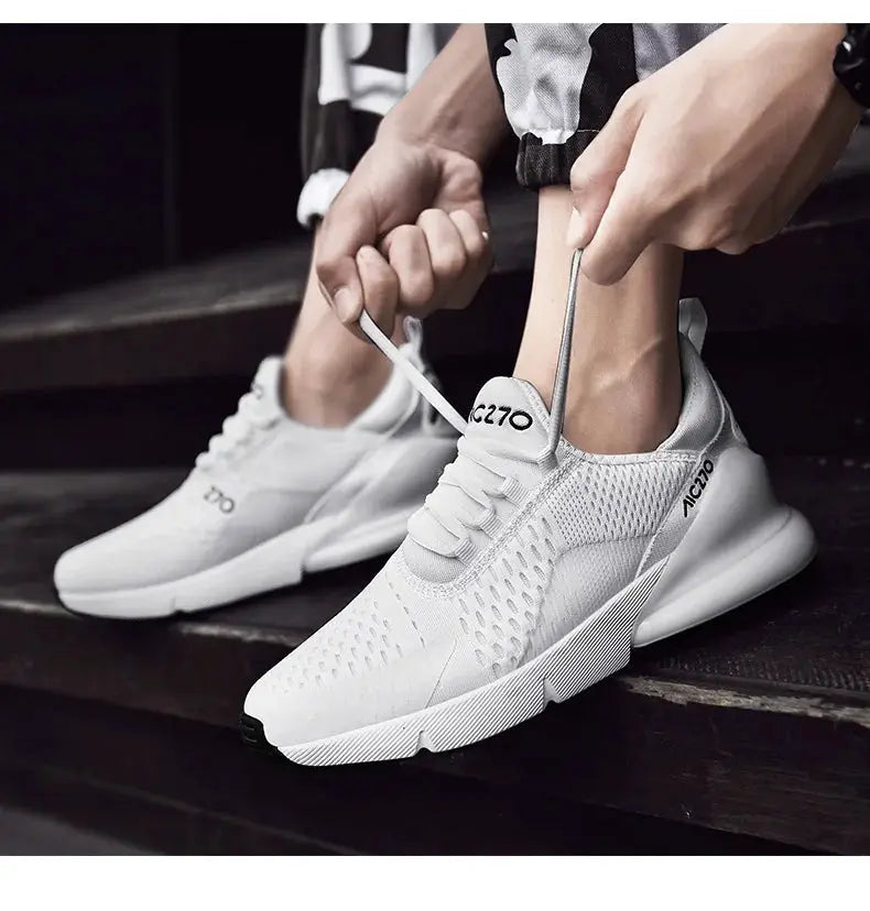 Men's white mesh sneakers with breathable upper and platform sole, 2 shoes on stairs
