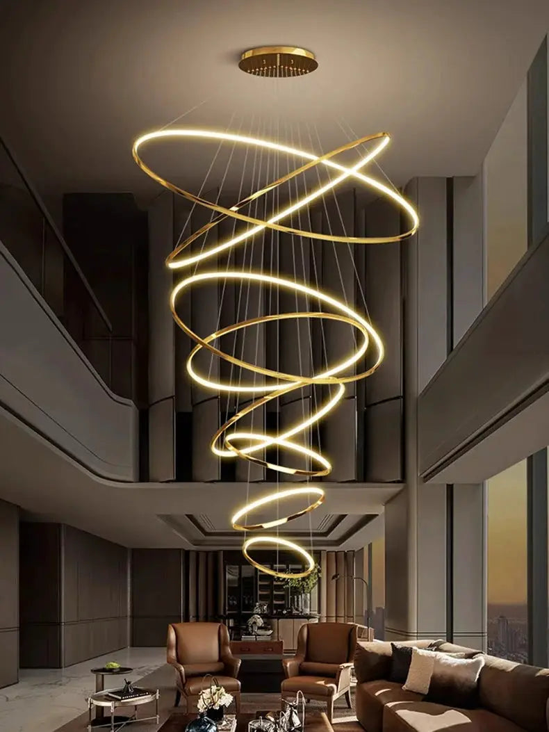 Spiral gold LED pendant light chandelier with helix rings over a modern living room