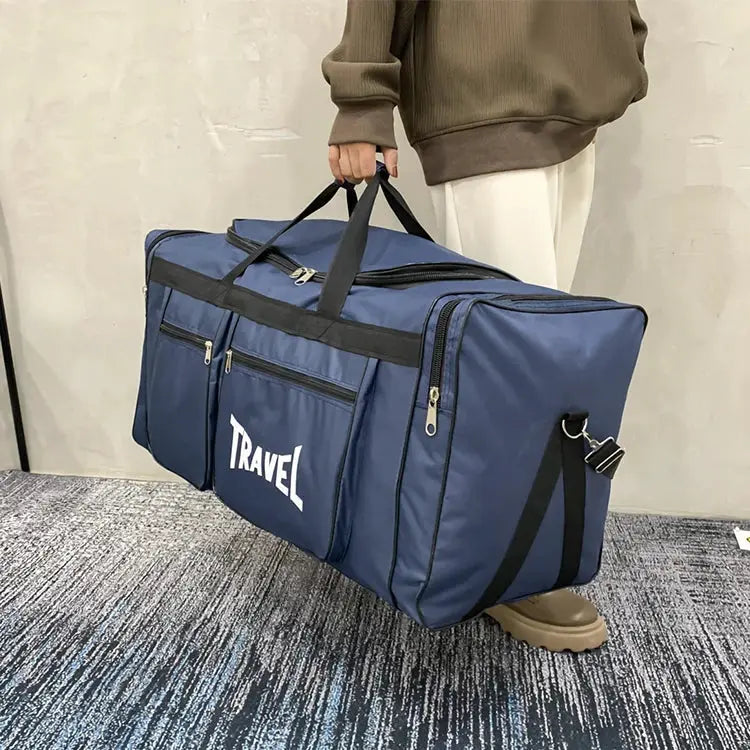 Large navy blue travel duffel bag with multiple zip pockets, top handles, and detachable shoulder strap.