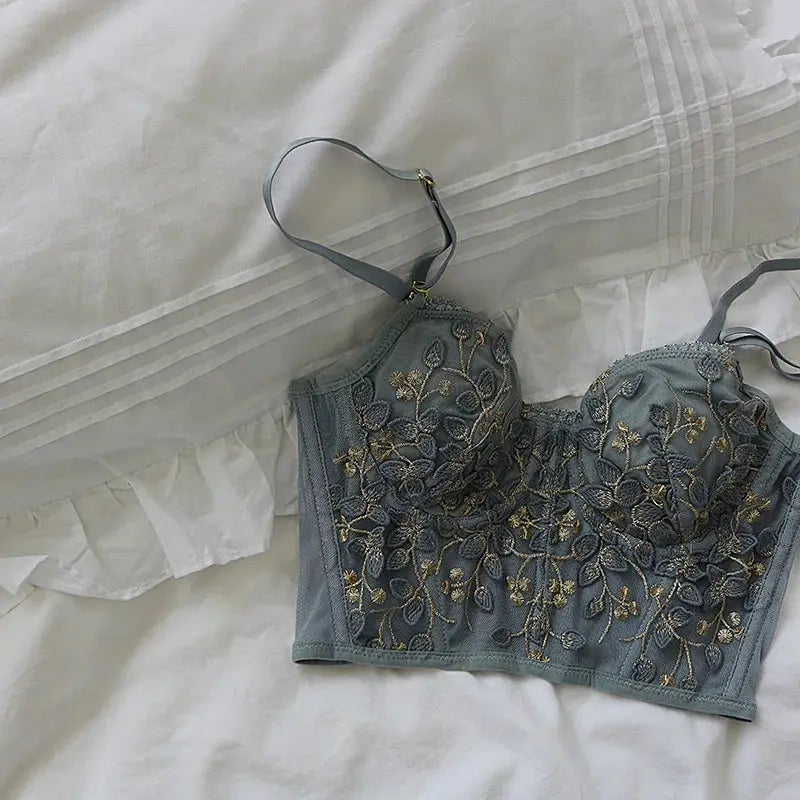 Simples Market three-dimensional embroidered lace bra with gray-blue fabric and gold floral embroidery.
