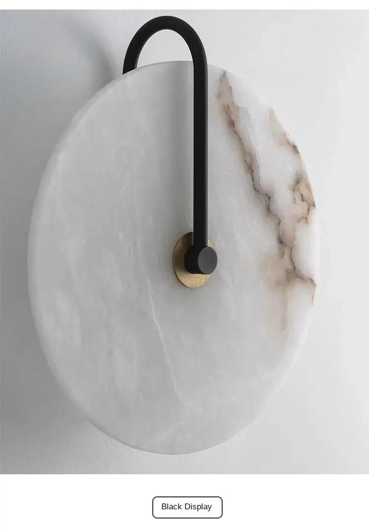 Nordic round marble moon backplate wall sconce with black curved arm and brass base