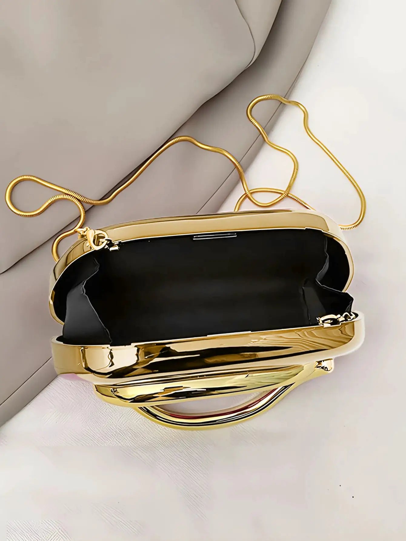 Acrylic box clutch by Simples Market, gold-tone frame with black interior and gold chain strap