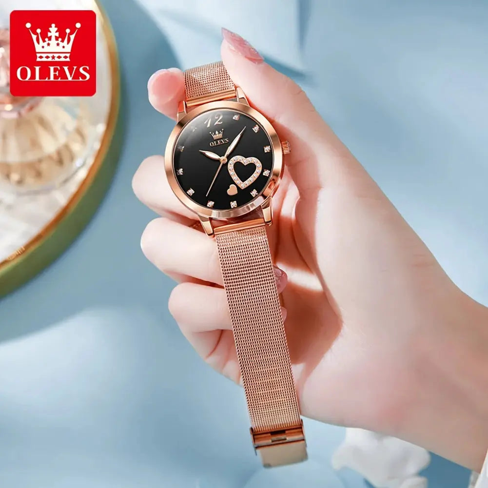 OLEVS women's quartz watch with rose-gold mesh strap, black dial featuring a heart motif and diamond hour markers.