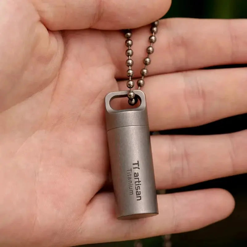 Tiartisan Titanium mini pill container on a ball-chain necklace; compact, waterproof EDC pill bottle