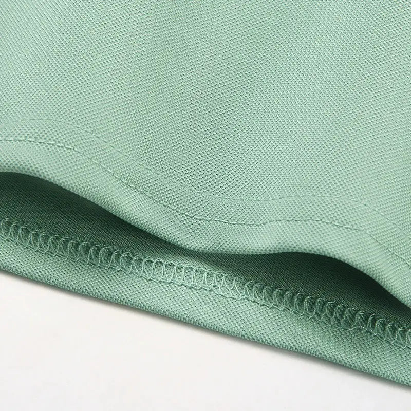 Men's polo shirt mint green fabric close-up; breathable pique knit, short sleeves