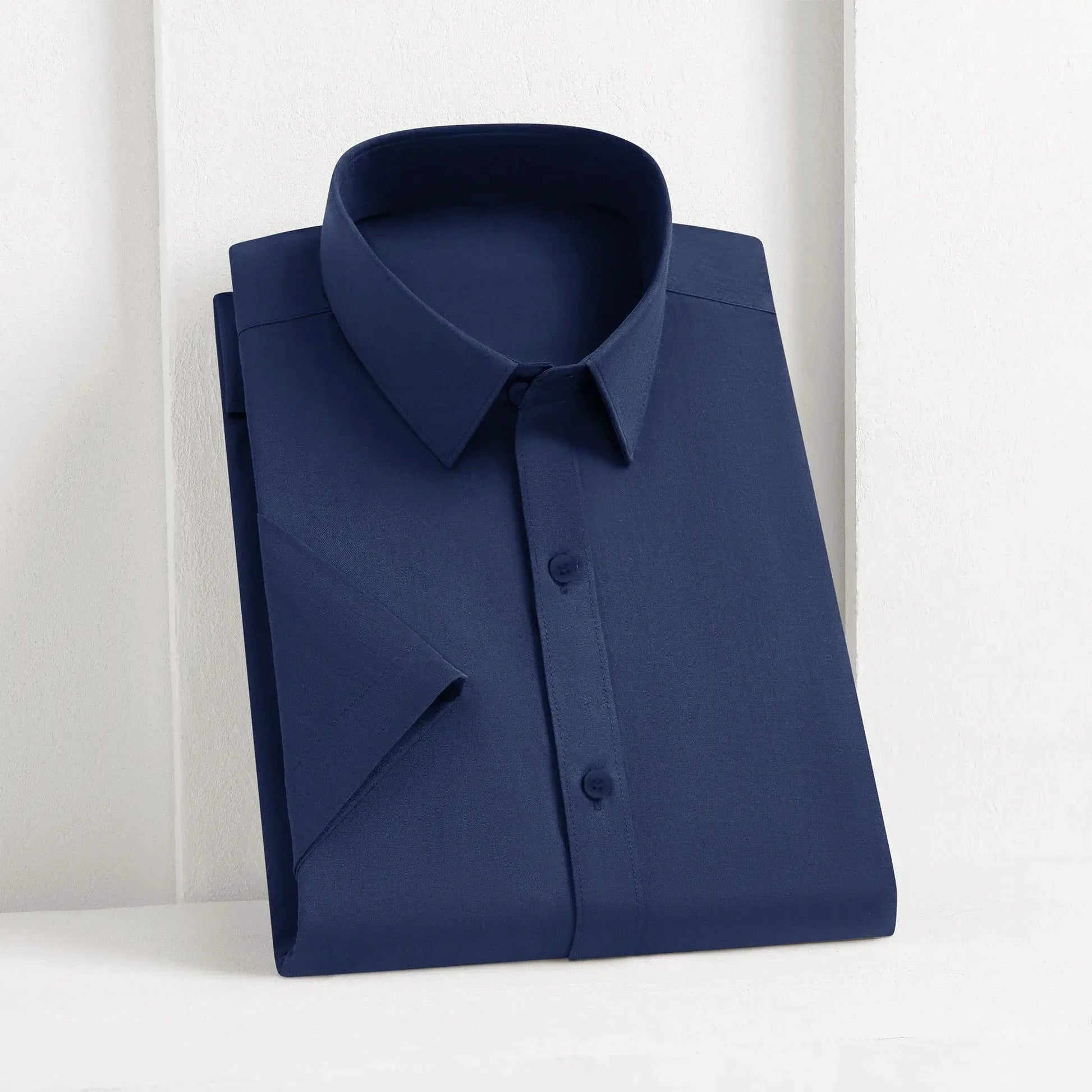 Men's navy blue solid shirt, button-front collared dress shirt folded for display