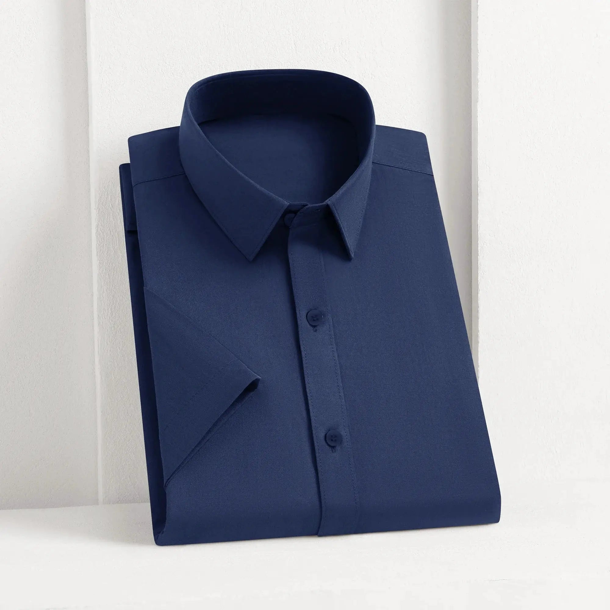 Men's navy blue solid shirt, button-front collared dress shirt folded for display