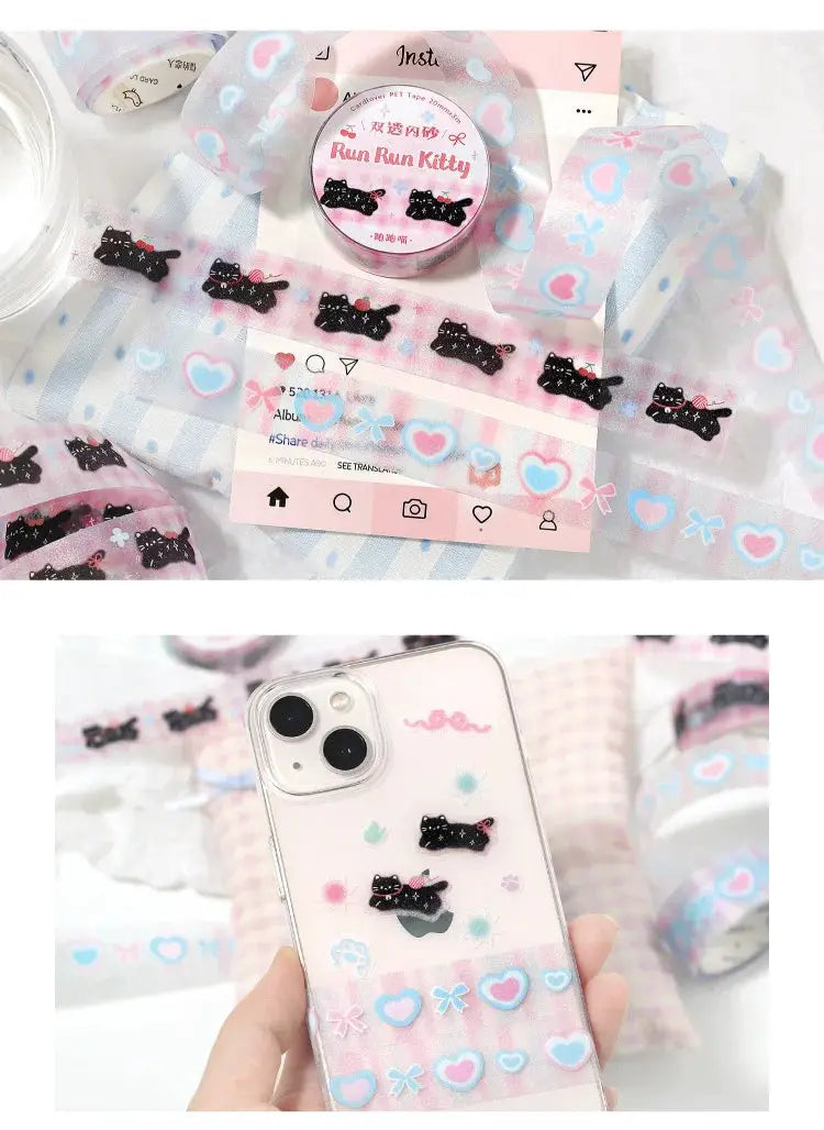 Decorative adhesive tape roll with pastel pink/blue heart patterns and black cat motifs