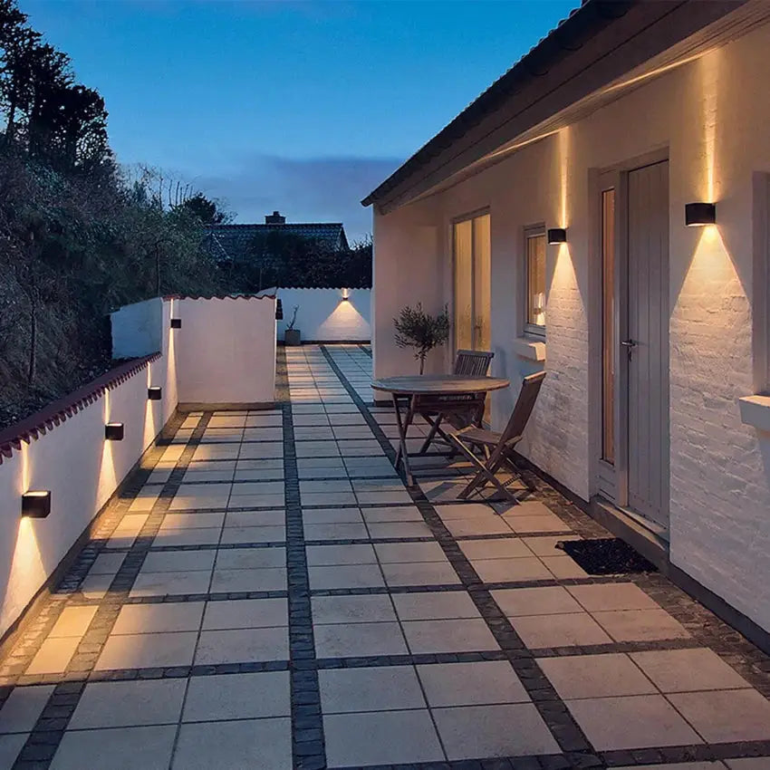 MARPOU LED wall lamp by Simples Market; black outdoor IP65 surface-mounted wall lights along a patio