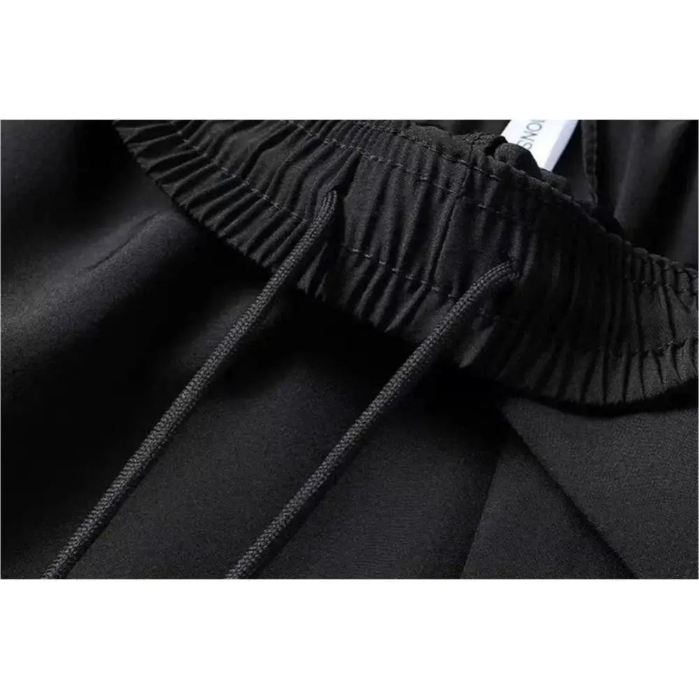 Men's black athletic shorts with elastic waistband and drawstring.