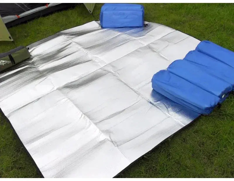 Simples Market camping mat with aluminum insulation; reflective silver sleeping pad on grass with blue foam pads