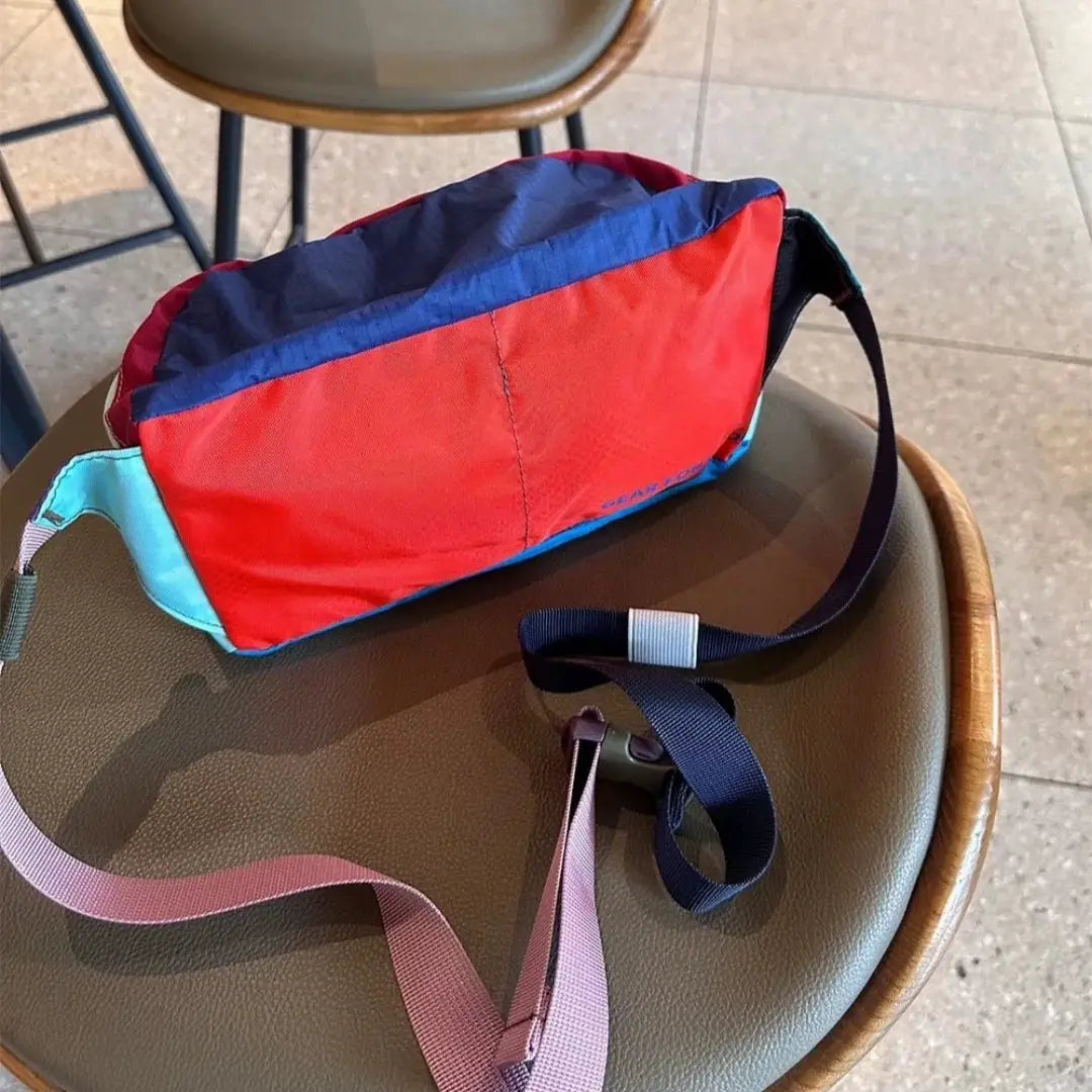 Waist bag by Simples Market, red and blue crossbody pouch with large capacity and pink and navy straps.