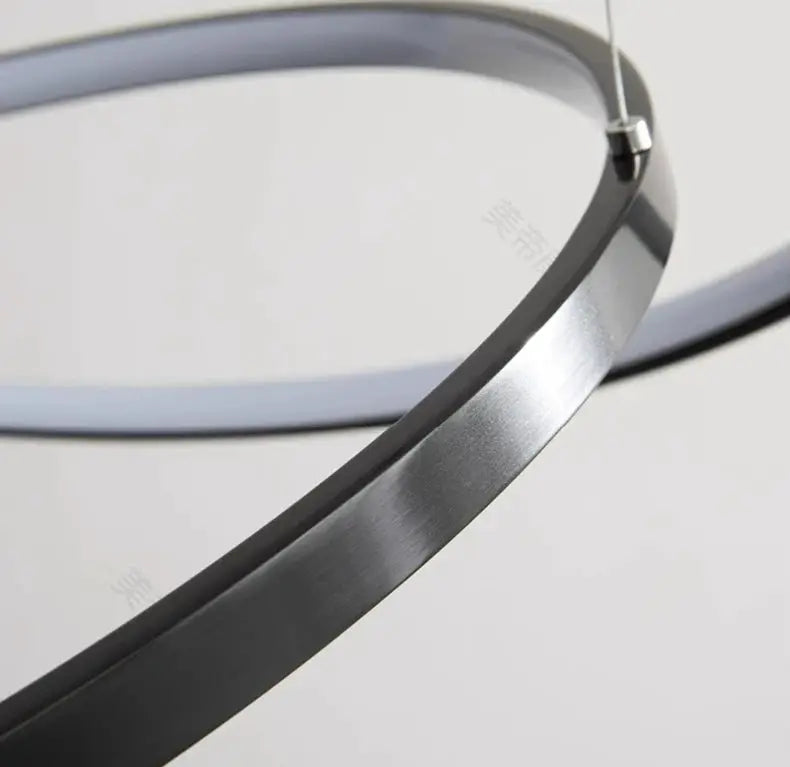 Circular brushed-metal LED pendant light ring by Simples Market for living room and staircase