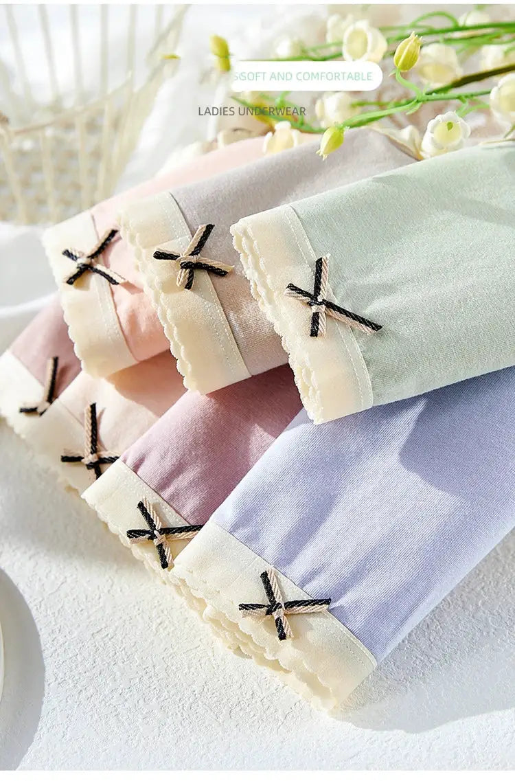 7Pcs women's cotton panties set by Simples Market in pastel colors with bow accents.