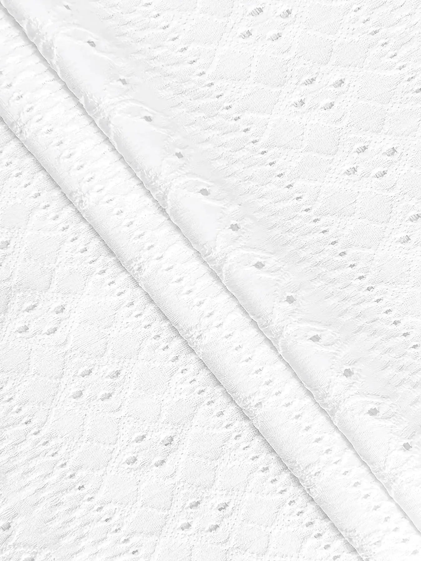 Simples Market white lace blouse fabric close-up, showing delicate dotted pattern and sheer texture.