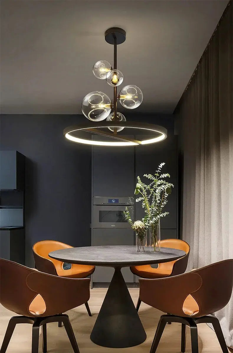 Modern Art Glass Chandelier by Simples Market with clear glass globes and a circular LED ring above a dining table.