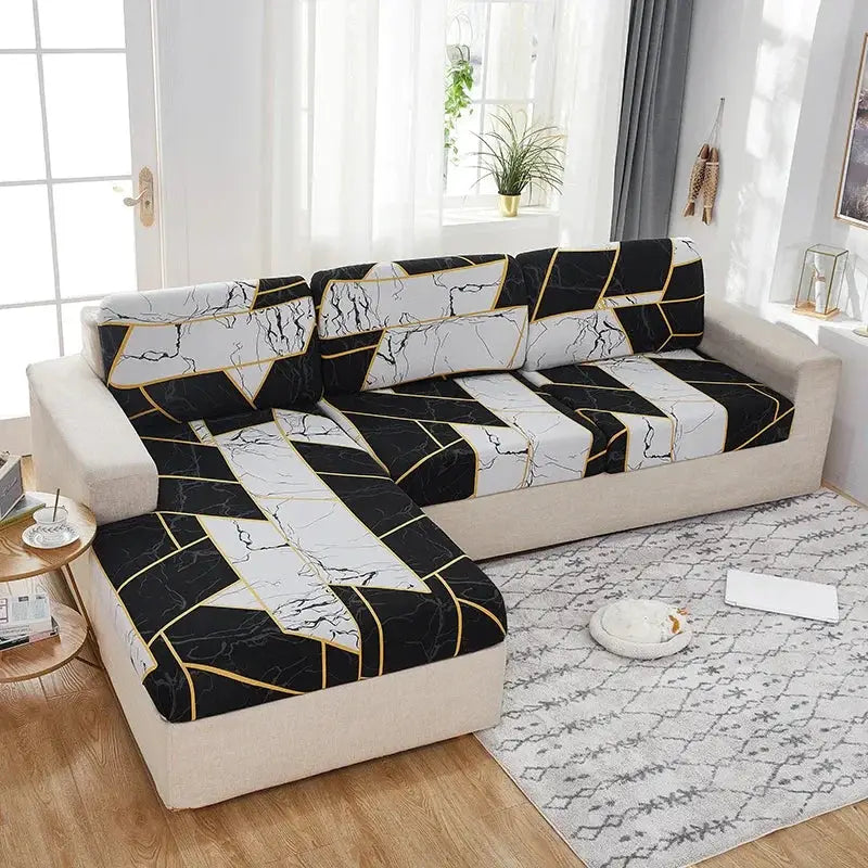 Elastic sofa cover in black and white marble pattern with gold accents on a beige sectional sofa