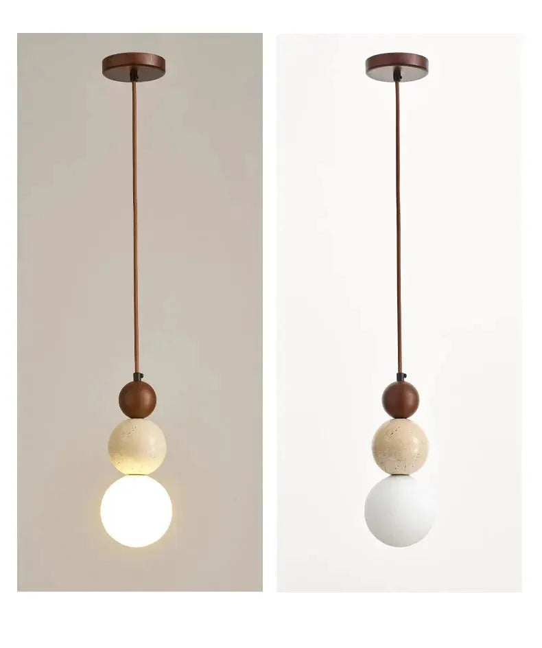 Pendant lamp with three stacked spheres on a brown cord: brown top bead, beige middle sphere, white bottom globe.